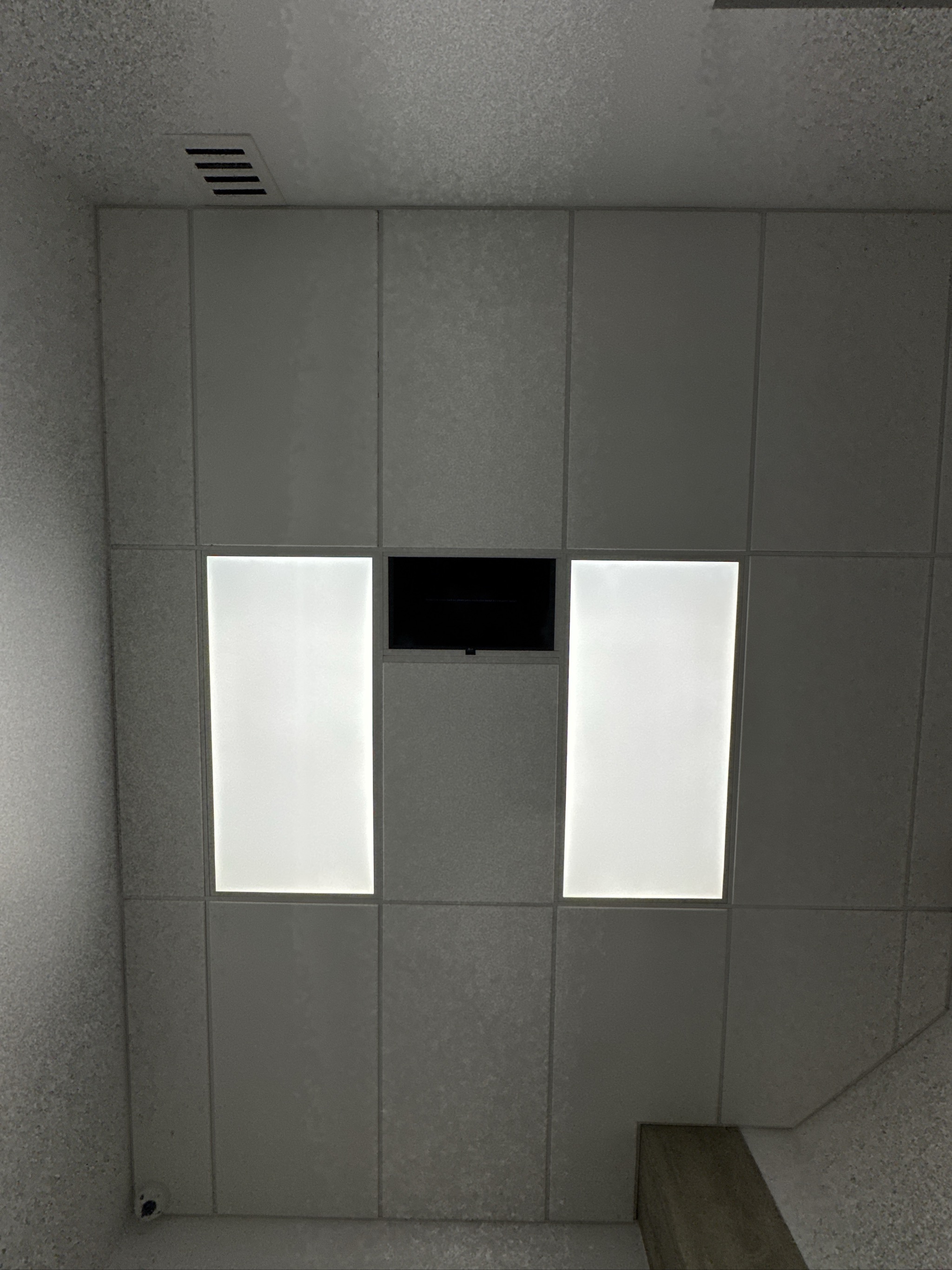 Modern built-in wall unit with illuminated panels and mounted TV.
